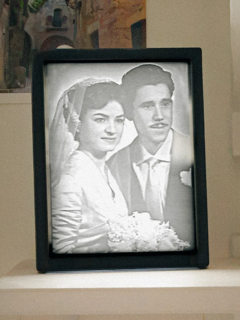 A finished frame, lit: an old black-and-white photograph of a couple.
