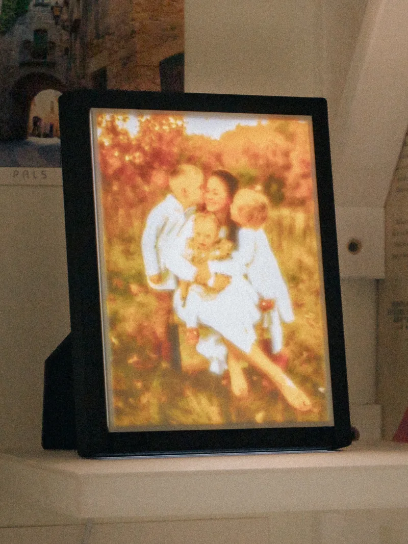 A finished frame, lit: a family photograph.